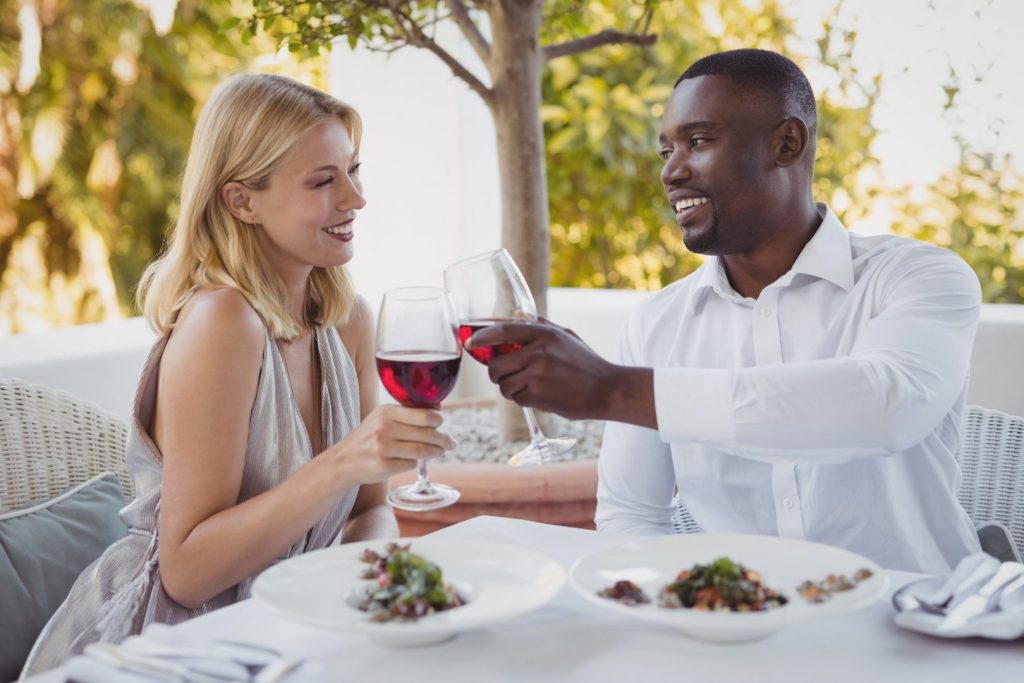 Romantic couple toasting their wine glasses