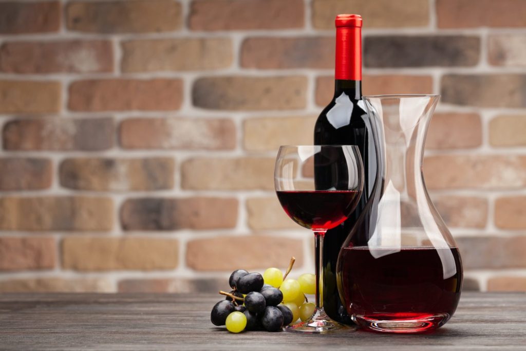 Wine decanter, bottle, glass of red wine